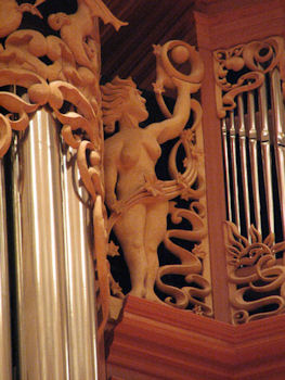 Life-sized wood carved sculpture of woman with orb, pipe shade carvings at Fritts organ at Pacific Lutheran University, master wood carver Jude Fritts